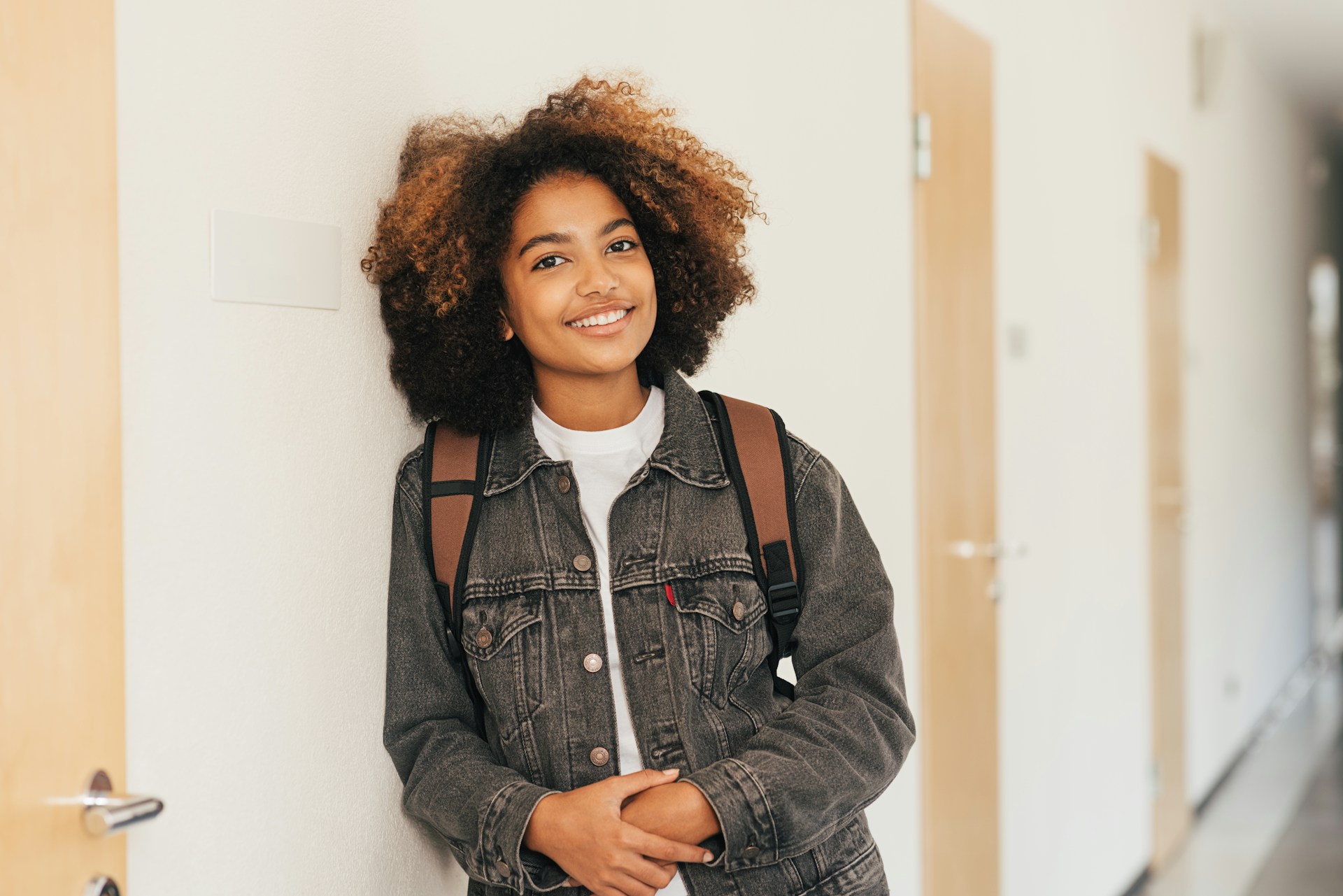 Smiling young person with a backpack